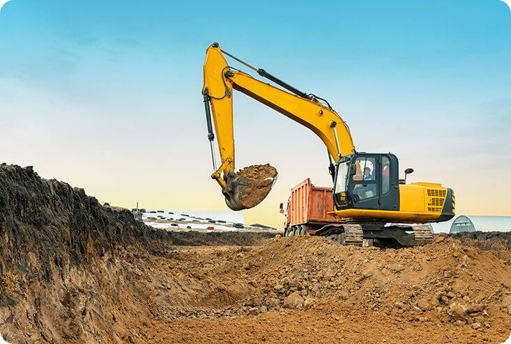 experienced excavating contractor shaping terrain for proper drainage