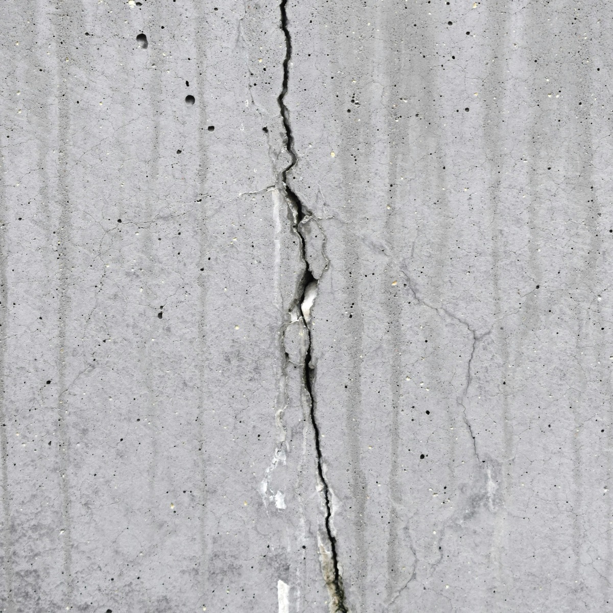 Close-up of a deep vertical crack in a concrete foundation, showing structural damage requiring foundation repair in Fort Lauderdale, FL.